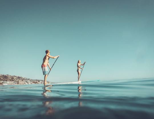 Two paddle boarders in Laguna Beach