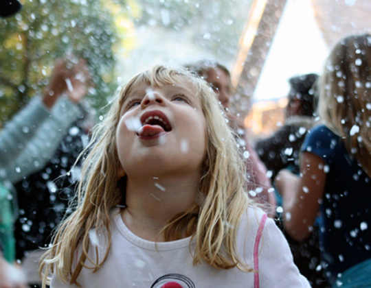 snowflake on tongue of child at Sawdust Art Winter Fantasy